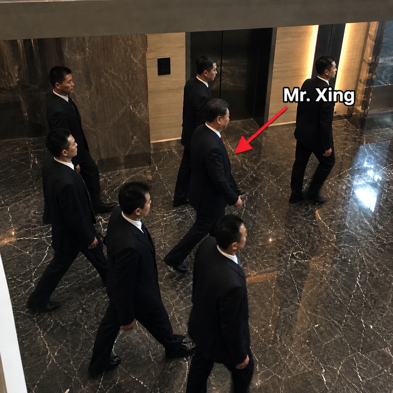 Mr. Xing — a well-dressed Chinese tycoon in a tailored suit